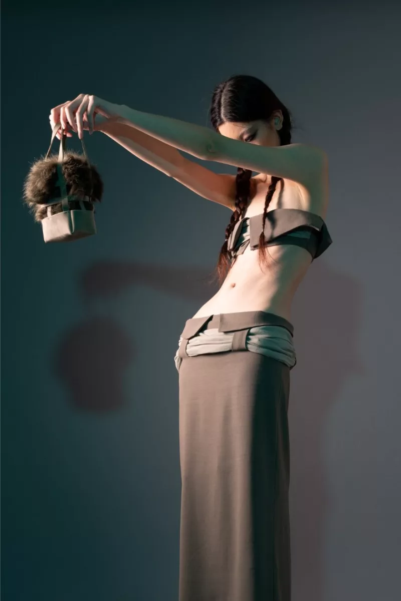 A model wearing a long skirt and bra top from Wenxin’s BFA thesis collection from Parsons fashion school