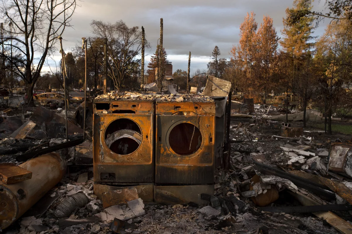 A burned out washer and dryer from Darcy Padilla's series documenting post fires brought on by climate change.